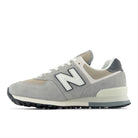 NEW BALANCE Unisex 574 Grey/Beige lifestyle sneaker, grey suede overlays on beige mesh, alternate side view.