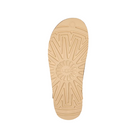 A tan rubber sole from UGG Womens Goldenstar Sand sandals features sunburst and zigzag tread patterns with the UGG logo in the center. Designed for platform styles, it delivers stylish comfort and foot pain relief on a white background.