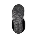 The image displays the black, textured sole of the UGG Womens Tazzette Slipper, featuring a zigzag pattern and the UGG logo embossed in the center.