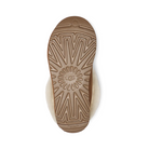 The image shows the sole of the UGG Womens Tazzette Slipper in Chestnut, featuring a textured Treadlite sole with the UGG logo at the center and the plush sheepskin lining peeking out for signature comfort.