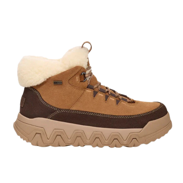 The UGG Womens Terretrail Cozy Lace Chestnut boot features a waterproof suede upper in tan and brown, thick zigzag-patterned sole for winter traction, metal eyelets, and a white faux-fur collar—perfect for cold weather and outdoor adventures.