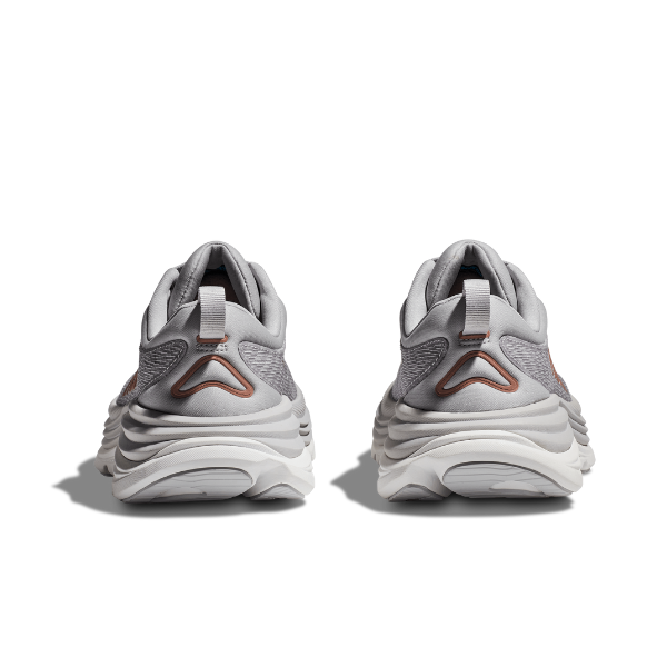 A pair of HOKA Womens Gaviota 5 Wide sneakers in Harbor Mist/Rose Gold are shown from the back, highlighting textured soles, heel pull tabs, and Stabilizing H-Frame technology for support—all set against a plain white background.