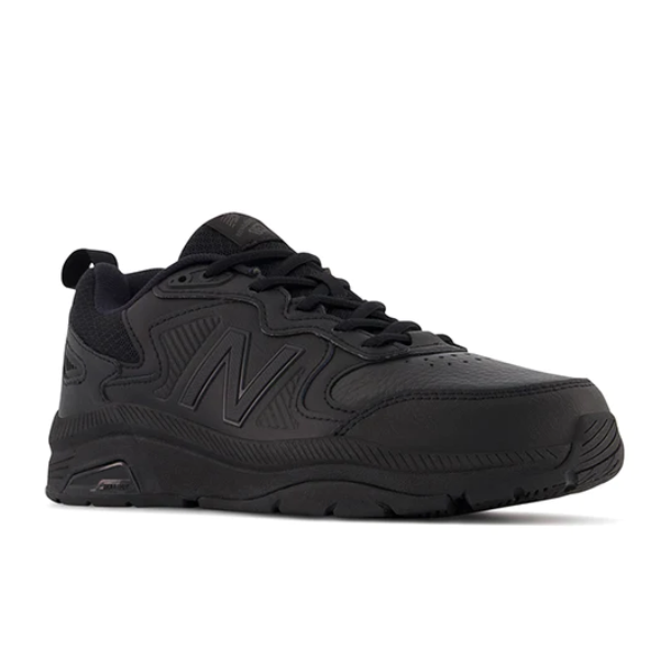 The New Balance Mens MX857 V3 Wide Black sneaker features a textured sole, lace-up design, N logo, and ROLLBAR technology—ideal for those seeking NEW BALANCE running shoes for foot pain, shown against a white background.