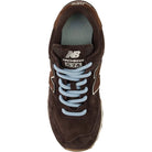 New Balance Women's 574 Black Coffee/Angora lifestyle sneaker, dark brown suede upper with warm cream accents.