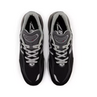 A top-down view of New Balance Mens 990 V6 Black running shoes with white laces and branded tongue, designed for both style and foot pain prevention.
