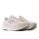 Top view of a pair of NEW BALANCE Women's 1080v15 Pink Salt running shoes, breathable mesh upper and pink laces.