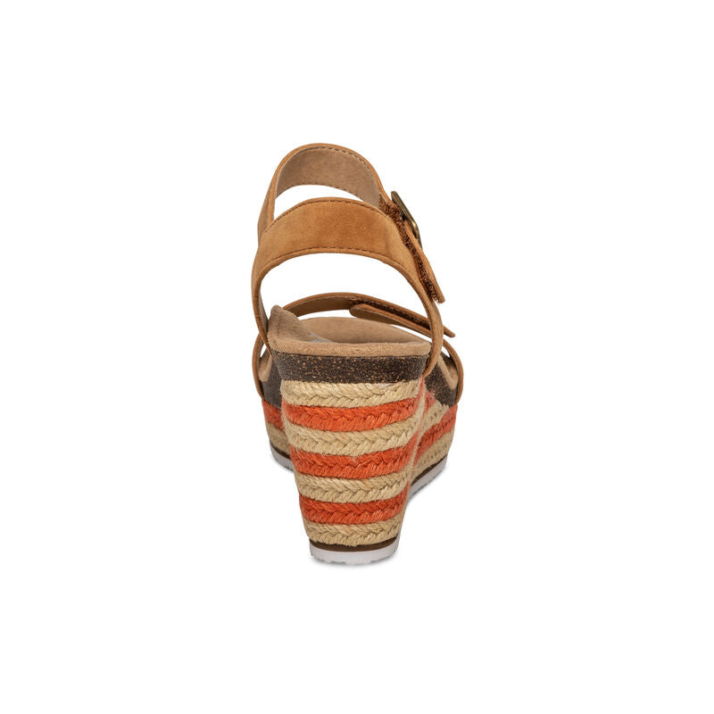 Rear view of the Aetrex Womens Sydney Cognac wedge sandal by Aetrex, showcasing a tan suede upper, adjustable espadrille strap, multicolored woven heel in beige, brown, and orange, and arch support for added comfort against a white background.