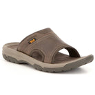The Teva Mens Langdon Slide Walnut features a Wide brown leather strap, open toe design, cushioned sole for comfort and pain relief, and is finished with a small yellow and black Teva logo on the side.