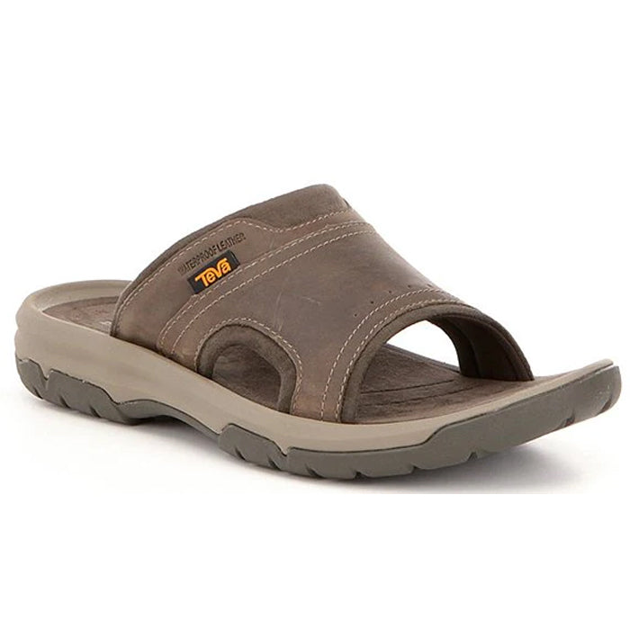 The Teva Mens Langdon Slide Walnut features a Wide brown leather strap, open toe design, cushioned sole for comfort and pain relief, and is finished with a small yellow and black Teva logo on the side.