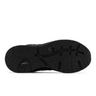The image displays the black rubber outsole of the NEW BALANCE Womens WX857 V3 Wide Black, highlighting textured zigzag and grid patterns for traction, ROLLBAR technology, and a small embossed logo near the center.