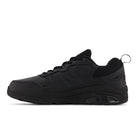 The New Balance Womens WX857 V3 Wide Black training shoe features a textured sole, mesh upper, lace-up front, side NEW BALANCE logo, and advanced ROLLBAR technology, shown in side view on a white background.