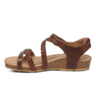 The Aetrex Womens Jillian Walnut sandal by Aetrex features braided and smooth brown leather, adjustable straps, a cushioned tan footbed, and a low cork wedge heel, shown in profile.