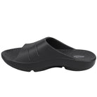 The Sovella Mens PF Slide Black is a black slip-on sandal with a contoured footbed, arch support, textured sole, and two grooves on the top strap. The Sovella brand is visible on the insole, making these comfort recovery sandals great for daily wear.